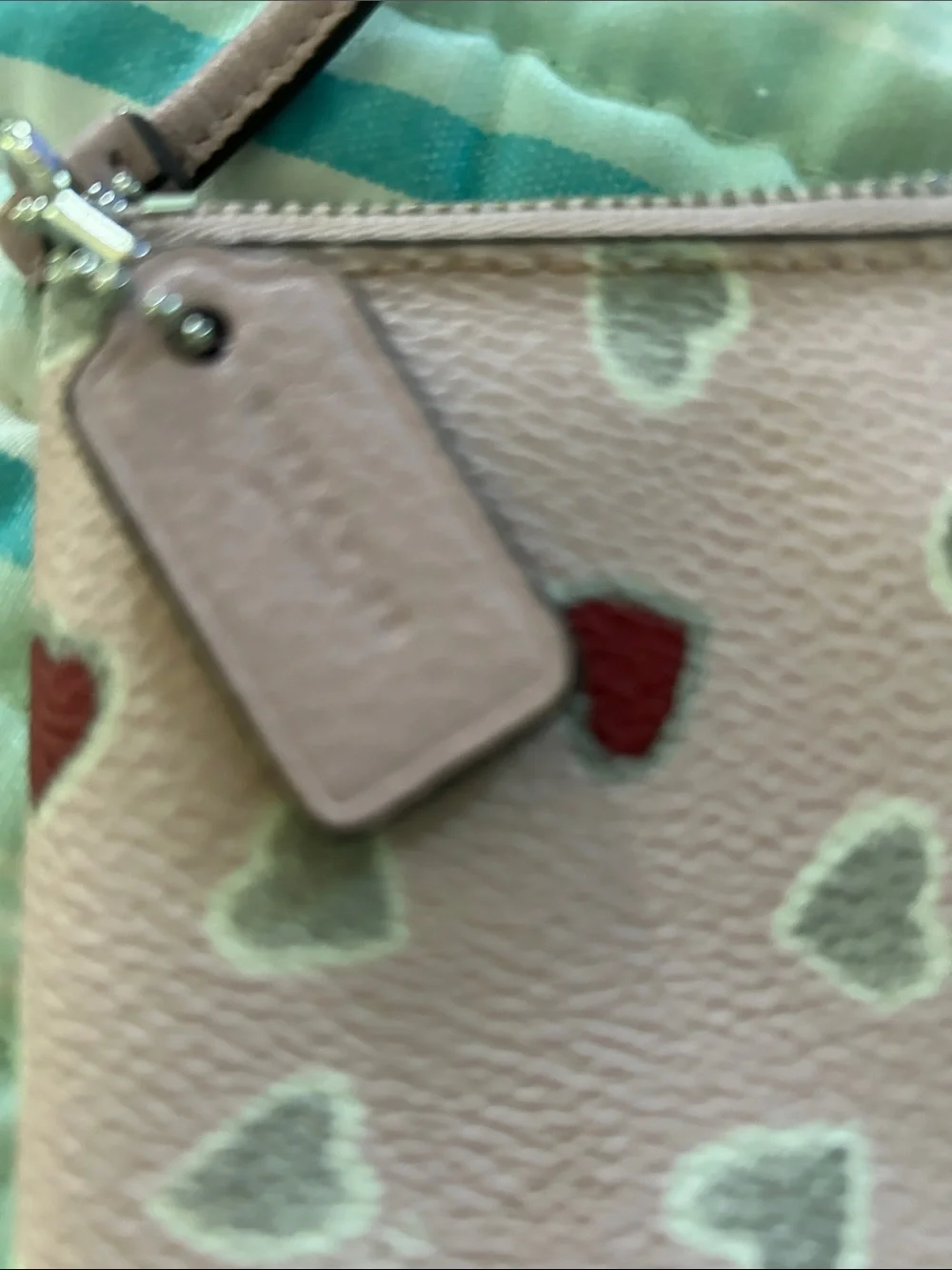 Coach Pink Leather Heart Wristlet with Red & Silver Hearts.  Two small marks